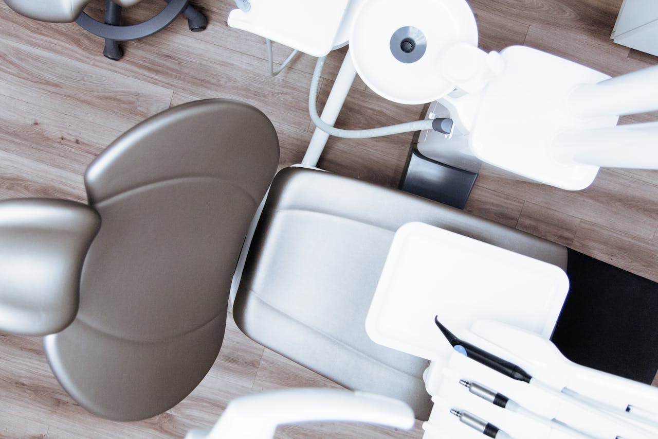 about-us-01 High-angle view of a modern dental chair and equipment setup in a professional clinic.